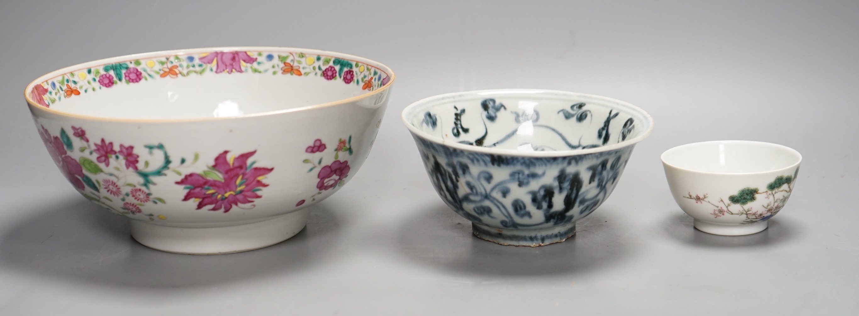 A Chinese Ming blue and white bowl, a larger famille rose bowl and a tea bowl, largest 21cm